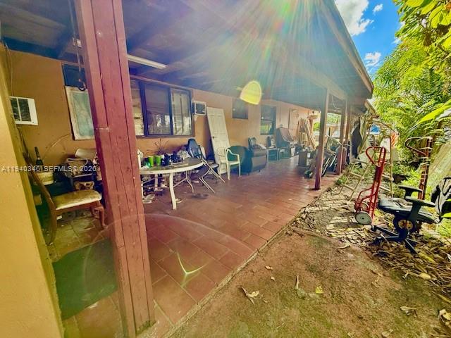 167 East 16th Street Hialeah, FL 33010 - Photo 3 of 4 a view of a patio with table and chairs and potted plants