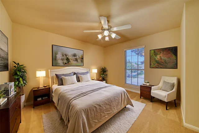 a bedroom with a bed and a potted plant