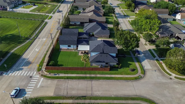 an aerial view of a house with a yard