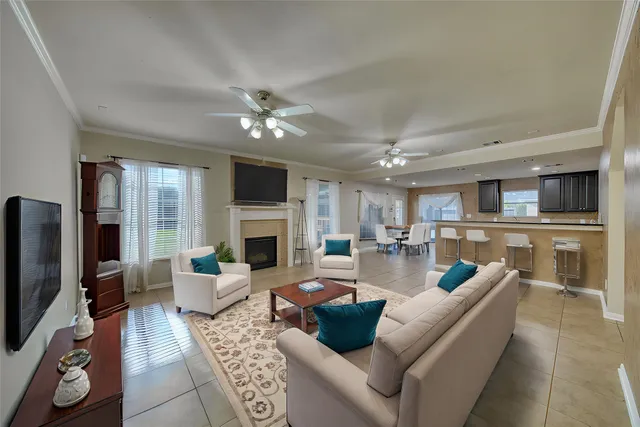 a living room with furniture a rug and a chandelier