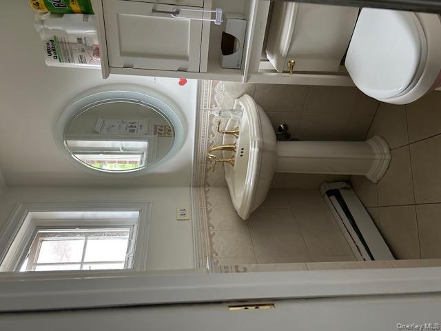 22-05 80th Street Queens, NY 11370 - Photo 11 of 17 a bathroom with a toilet sink and mirror