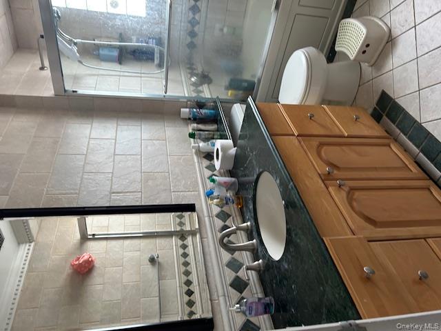 22-05 80th Street Queens, NY 11370 - Photo 14 of 17 a bathroom with a granite countertop sink and a mirror