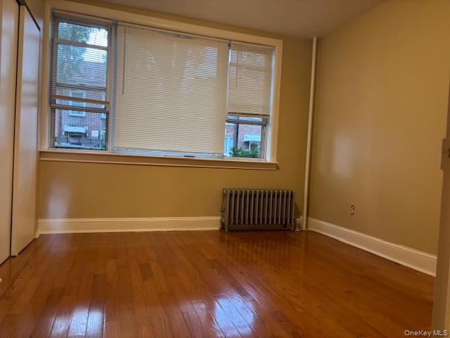 22-05 80th Street Queens, NY 11370 - Photo 17 of 17 a view of a room with wooden floor and windows