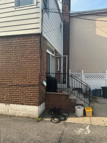 a view of a house with a patio and a yard