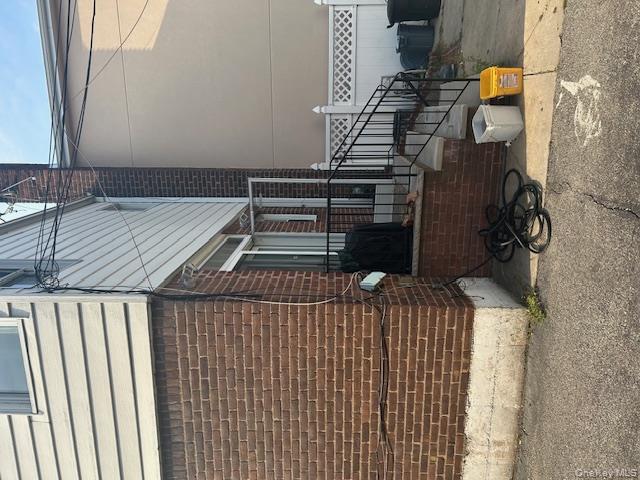 22-05 80th Street Queens, NY 11370 - Photo 3 of 17 a view of a house with a patio and a yard
