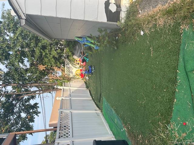 22-05 80th Street Queens, NY 11370 - Photo 4 of 17 a backyard of a house with lots of green space