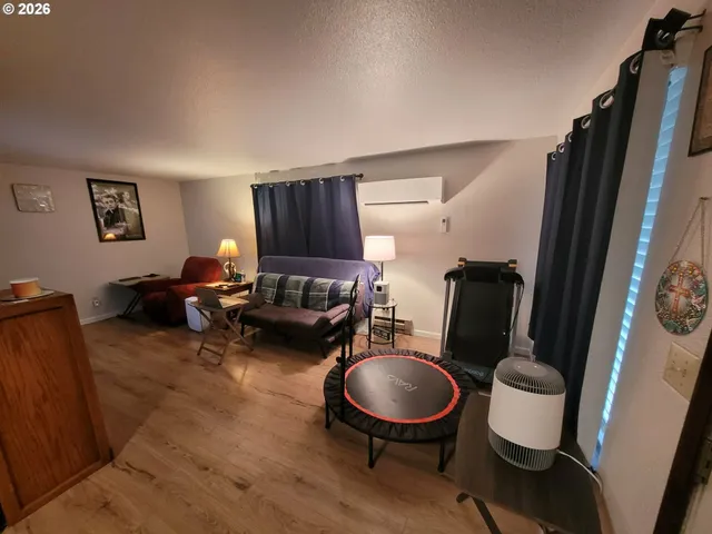 a living room with furniture and a mirror