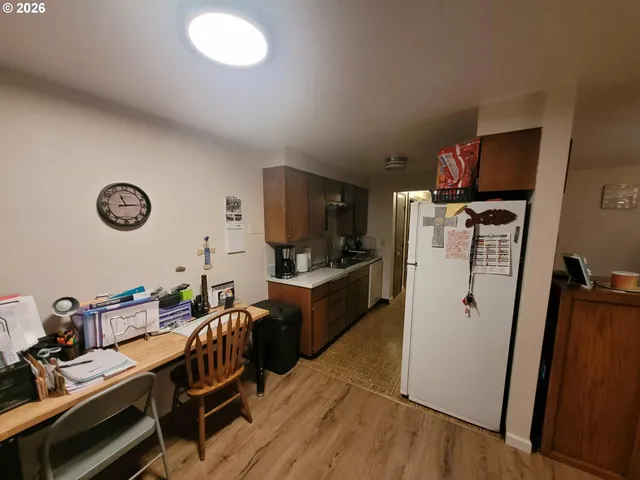 a kitchen with granite countertop a refrigerator stove and sink