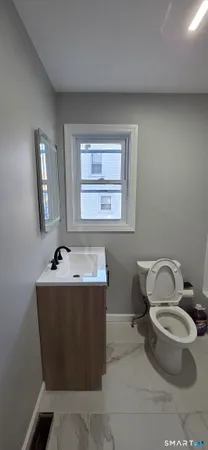 a room with a toilet and a window