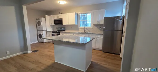 a kitchen with a refrigerator a stove top oven a sink and dishwasher
