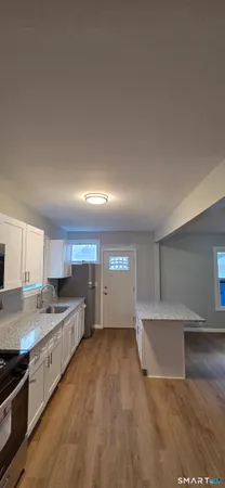 a kitchen with stainless steel appliances a refrigerator sink and cabinets