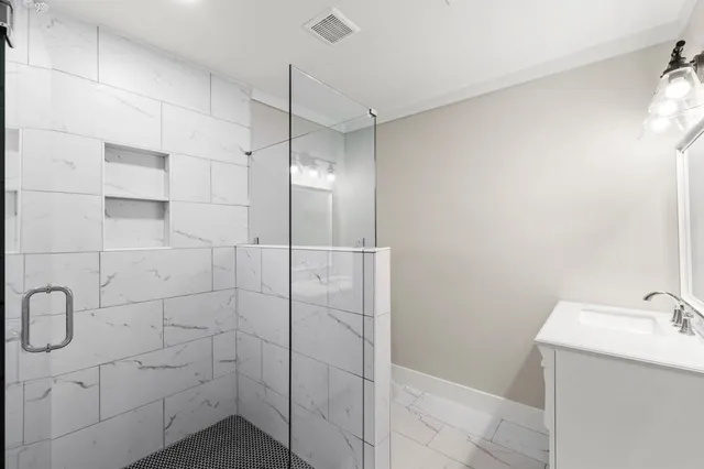 a bathroom with a shower and sink