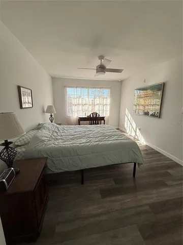 an empty room with wooden door and cabinet