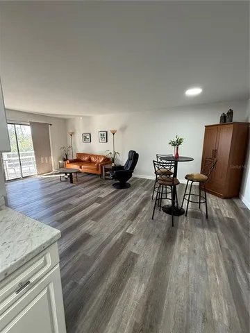 a kitchen with a refrigerator sink and cabinets