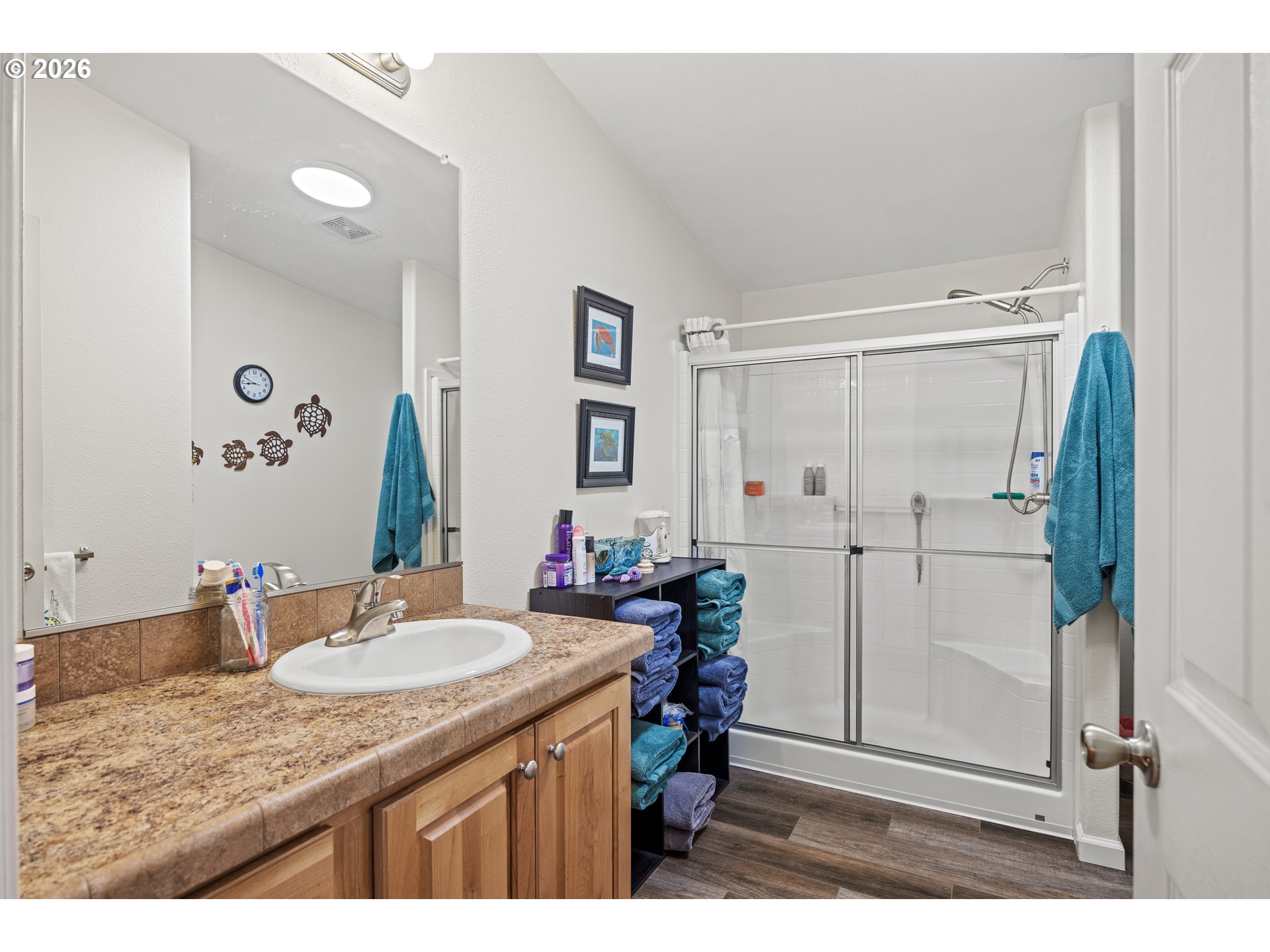 1050 North Cedar Point Road, Unit C09 Coquille, OR 97423 - Photo 22 of 38 a bathroom with a granite countertop sink a mirror and a shower