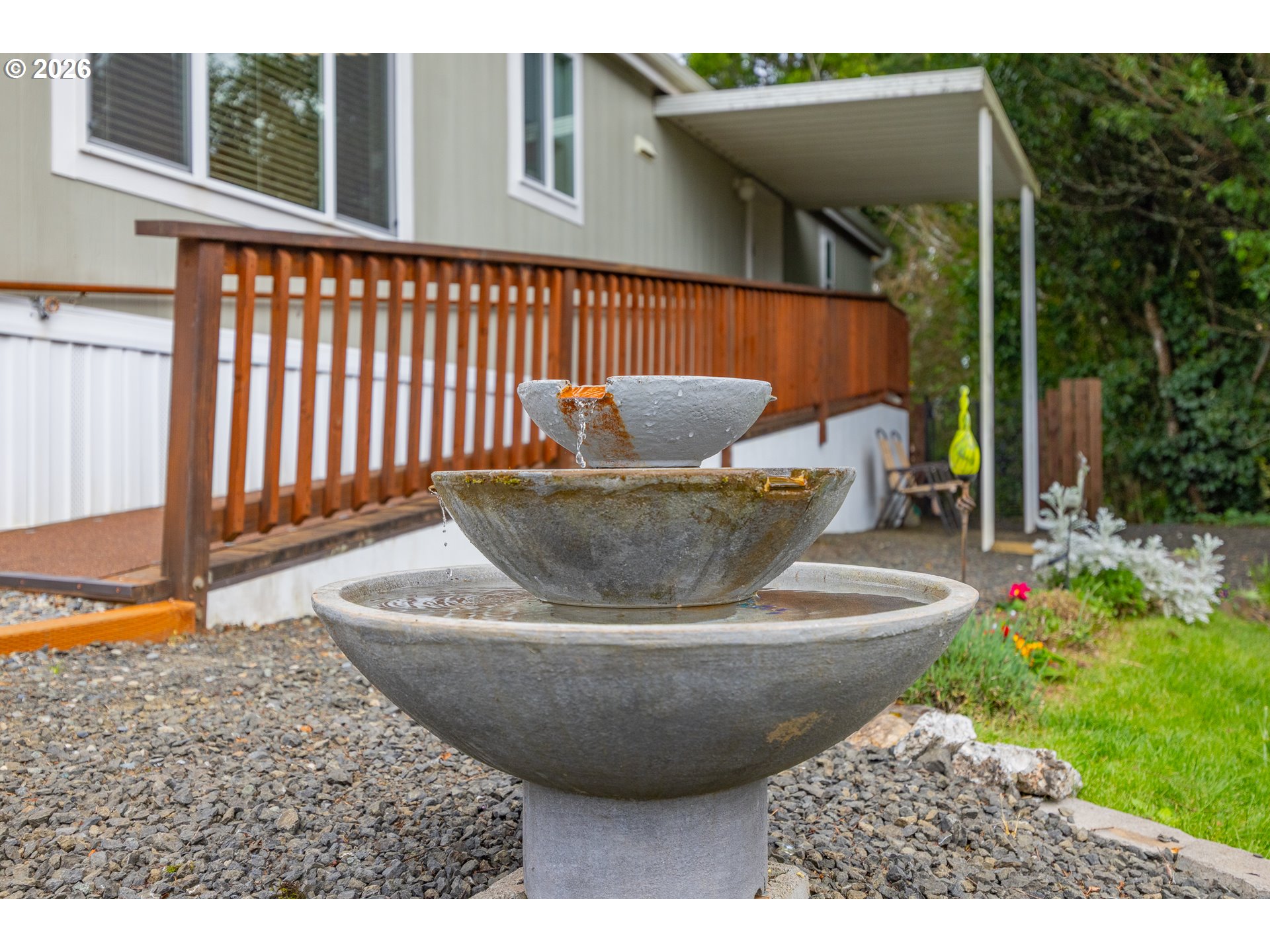 1050 North Cedar Point Road, Unit C09 Coquille, OR 97423 - Photo 29 of 38 a view of a patio with table and chairs potted plants with floor to ceiling window and potted plants