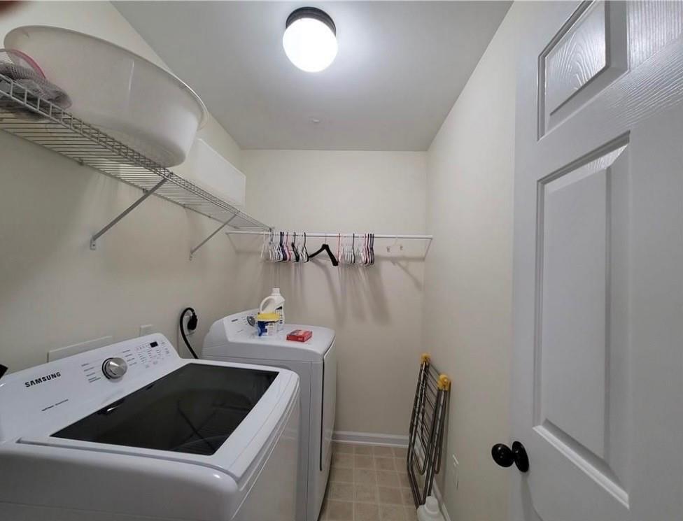4856 Gathering Place Suwanee, GA 30024 - Photo 17 of 18 a utility room with dryer and washer