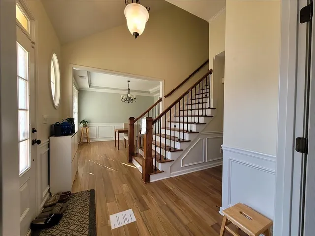 a view of entryway and hall with wooden floor