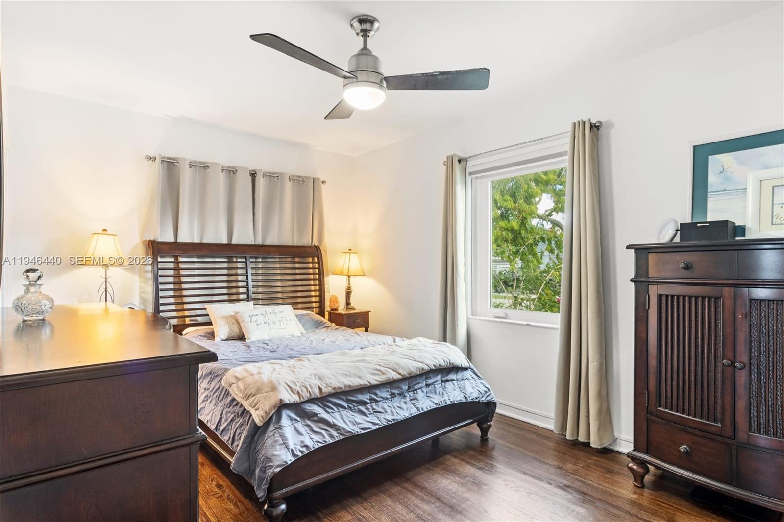 3151 Southwest 20th Street, Unit 1 Miami, FL 33145 - Photo 13 of 18 a bedroom with a bed window and wooden floor