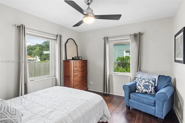 a bedroom with a bed couch and a window