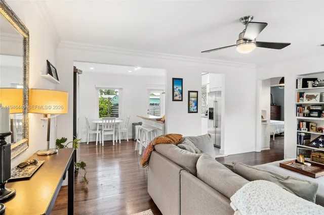 a living room with furniture a rug and a flat screen tv