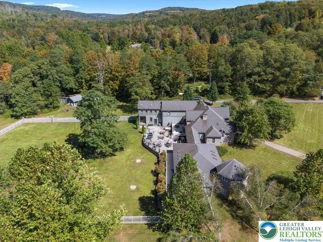 an aerial view of house with ocean view