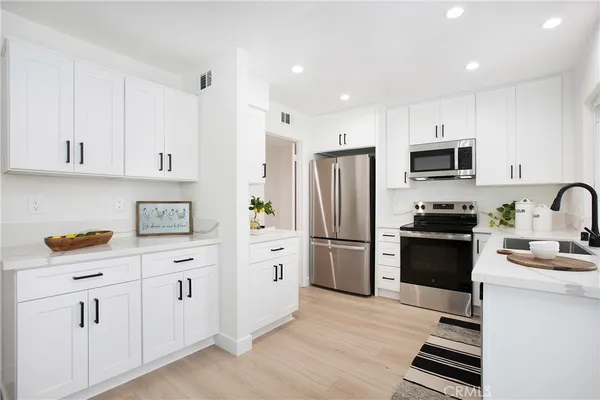 a kitchen with cabinets and stainless steel appliances