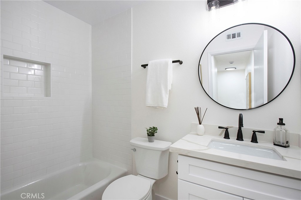 519 Breezewood Court Brea, CA 92821 - Photo 16 of 30 a bathroom with a sink a mirror and a toilet