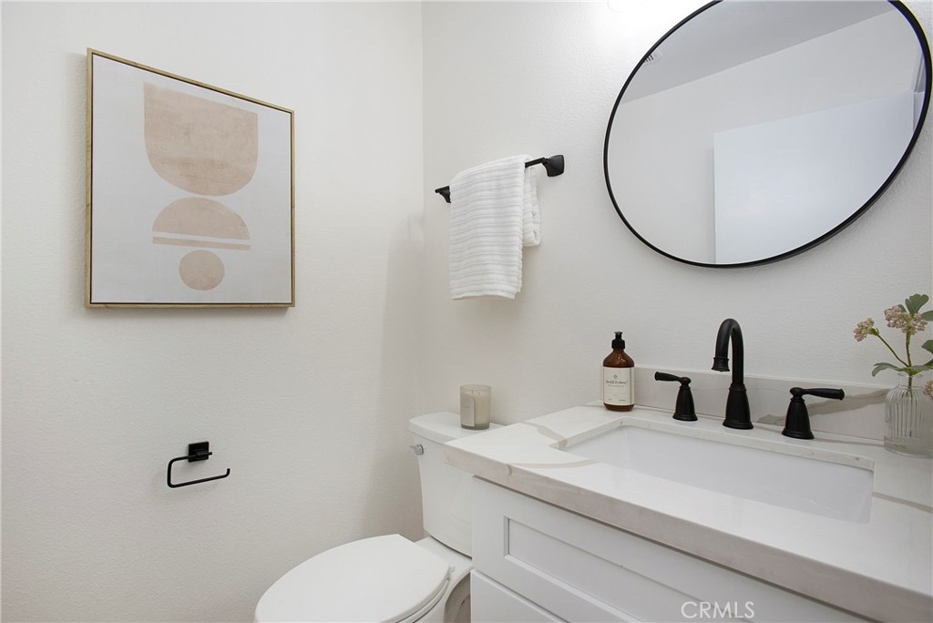 519 Breezewood Court Brea, CA 92821 - Photo 9 of 30 a bathroom with a toilet sink and mirror