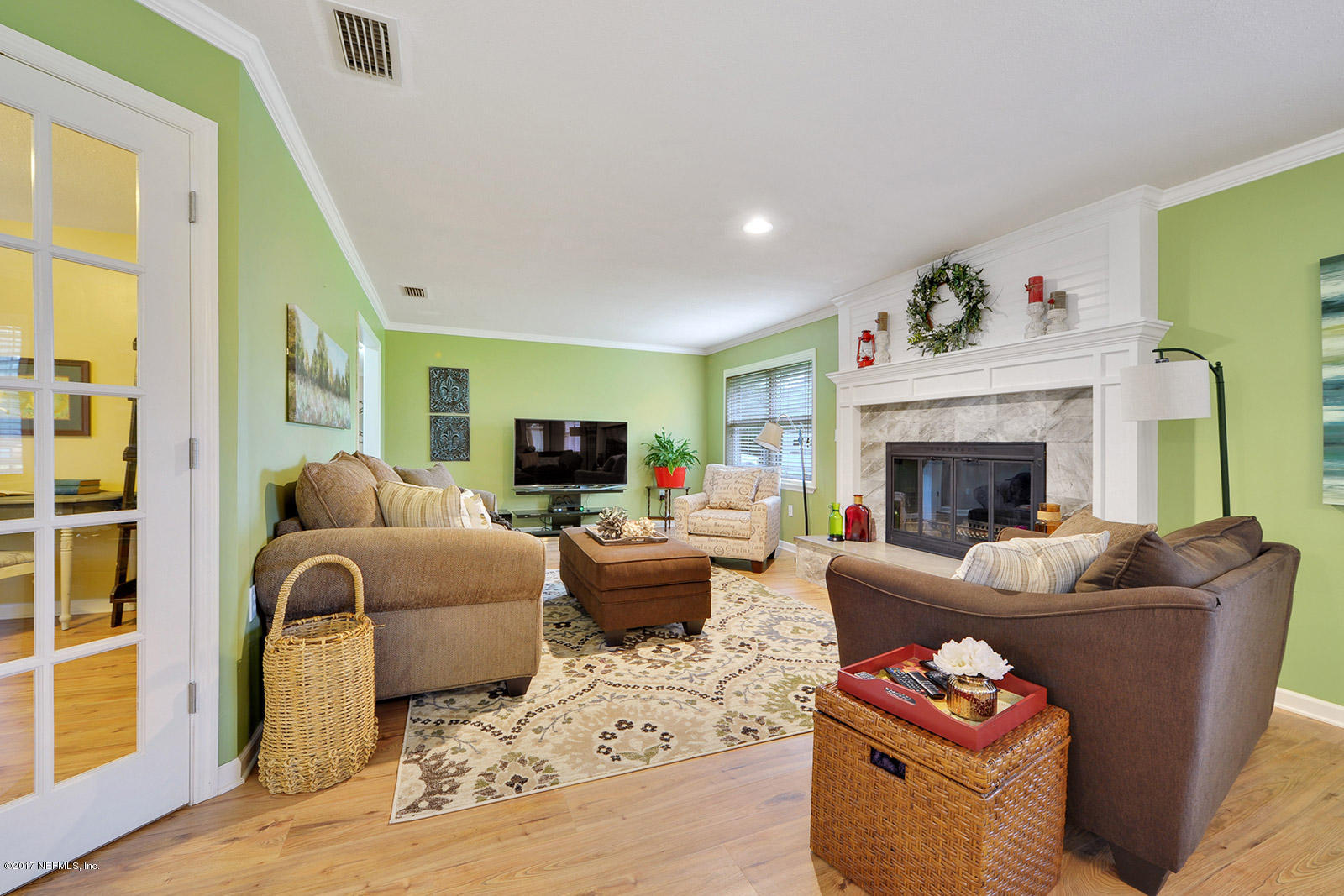 5280 Truman Pacetti Road St. Augustine, FL 32092 - Photo 14 of 34 a living room with furniture a fireplace and a flat screen tv