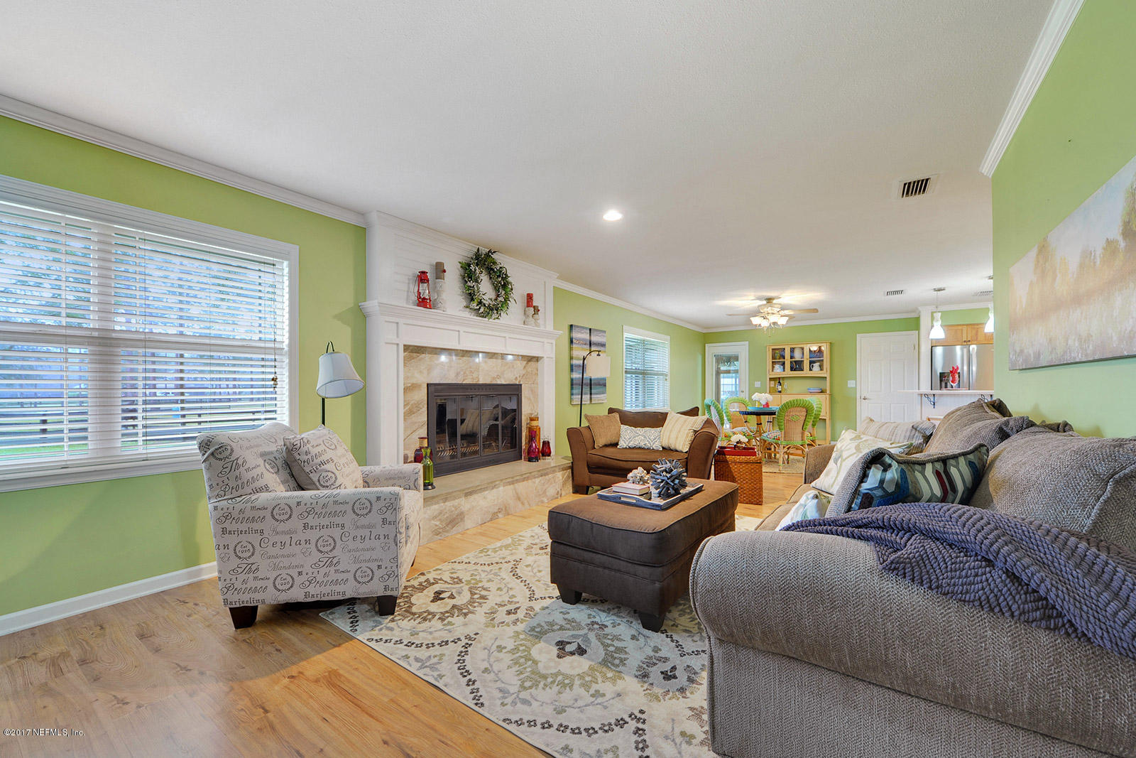 5280 Truman Pacetti Road St. Augustine, FL 32092 - Photo 15 of 34 a living room with furniture and a fireplace