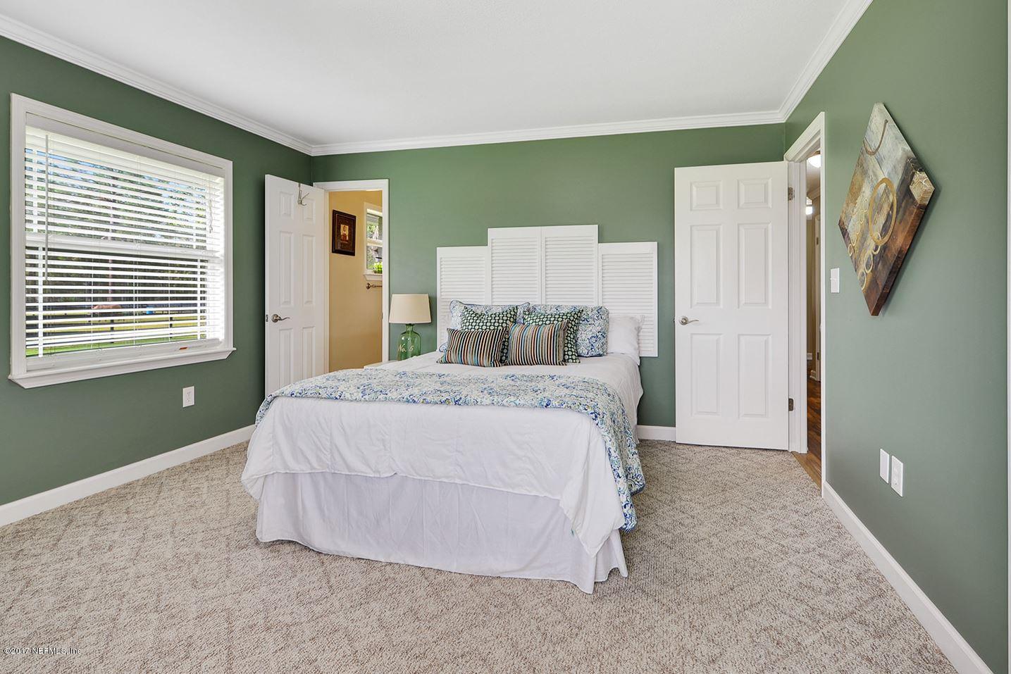 5280 Truman Pacetti Road St. Augustine, FL 32092 - Photo 17 of 34 a bedroom with a bed and window