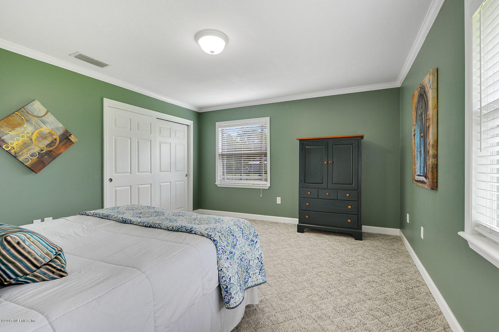 5280 Truman Pacetti Road St. Augustine, FL 32092 - Photo 19 of 34 a bedroom with a bed and a dresser