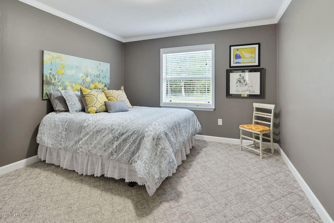 5280 Truman Pacetti Road St. Augustine, FL 32092 - Photo 20 of 34 a bedroom with a bed and a table