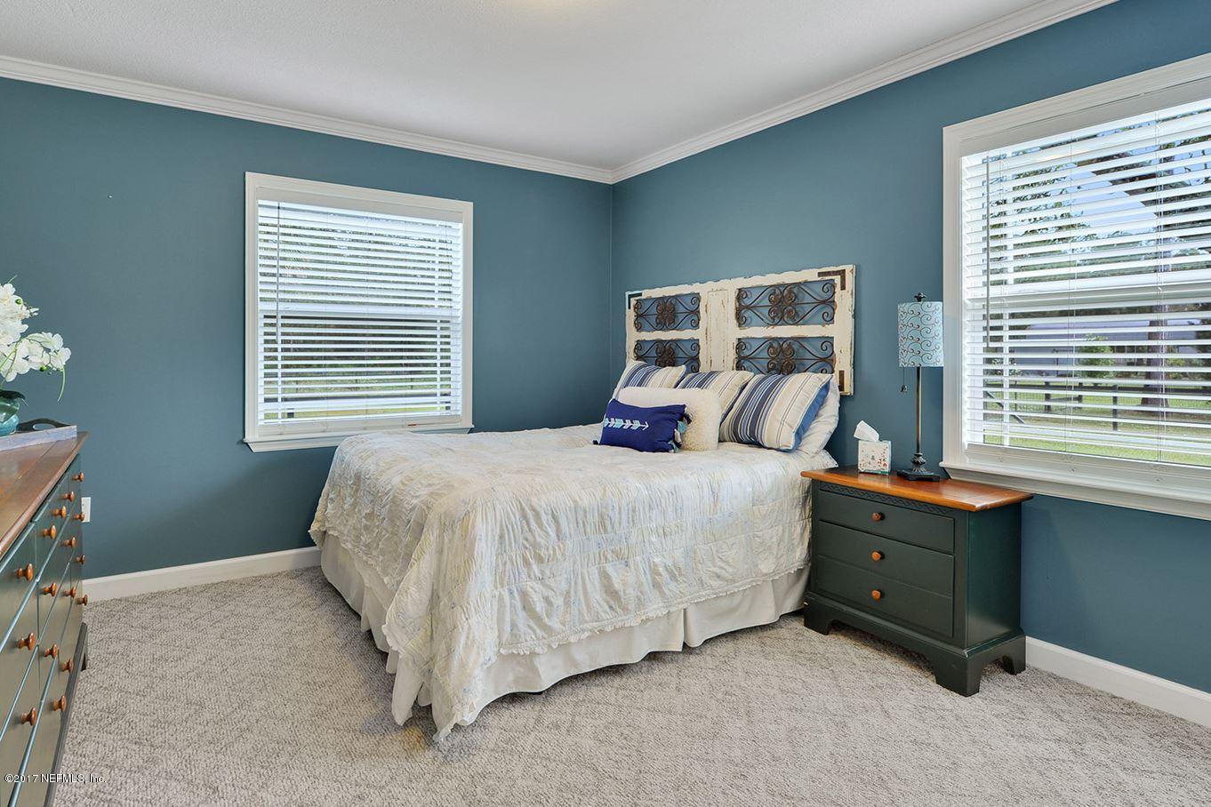 5280 Truman Pacetti Road St. Augustine, FL 32092 - Photo 21 of 34 a bedroom with a bed and a window