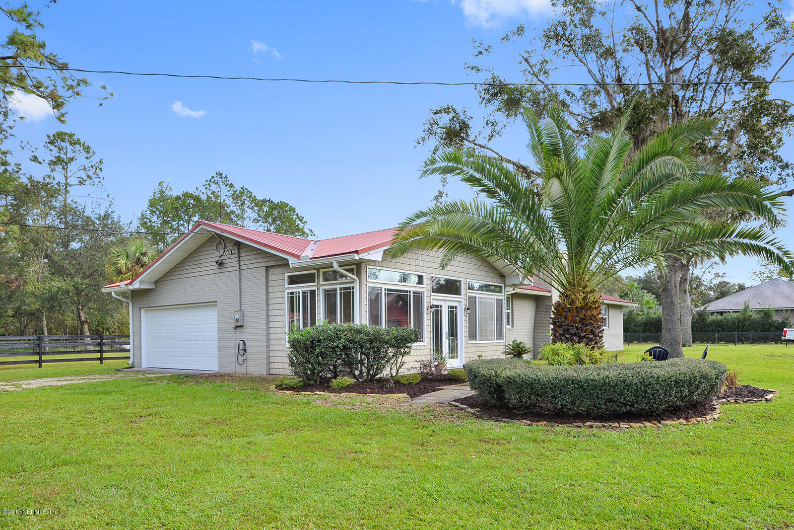 5280 Truman Pacetti Road St. Augustine, FL 32092 - Photo 25 of 34 a front view of a house with a garden and yard