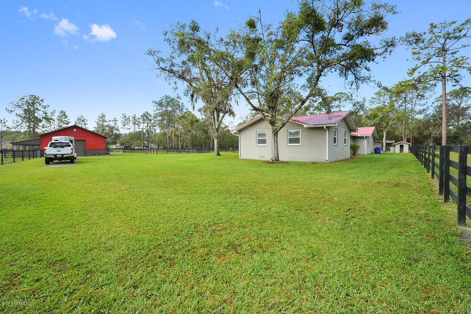 5280 Truman Pacetti Road St. Augustine, FL 32092 - Photo 27 of 34 a white house with a big yard and large trees
