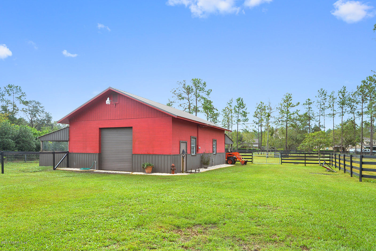 5280 Truman Pacetti Road St. Augustine, FL 32092 - Photo 31 of 34 a backyard of a house with lots of green space and outdoor seating