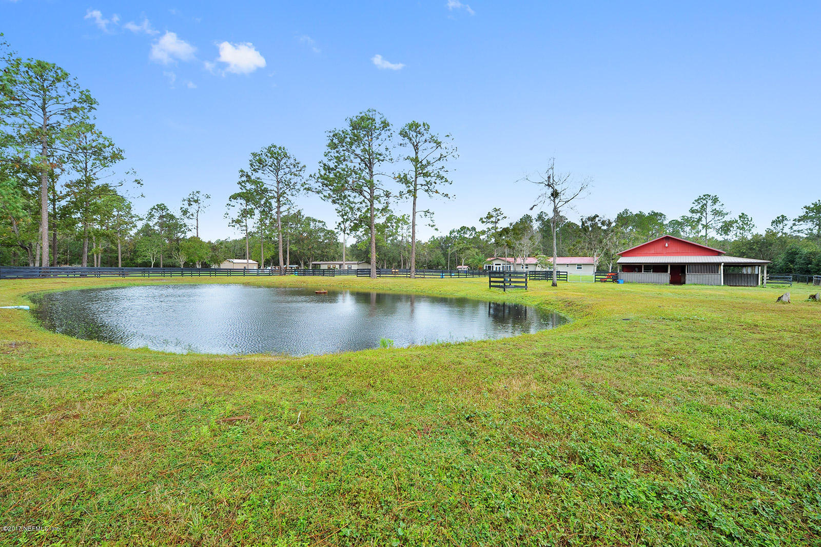5280 Truman Pacetti Road St. Augustine, FL 32092 - Photo 34 of 34 a view of a lake with houses in the background