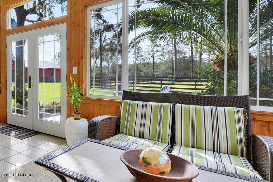 5280 Truman Pacetti Road St. Augustine, FL 32092 - Photo 4 of 34 a outdoor living space with furniture and a potted plant