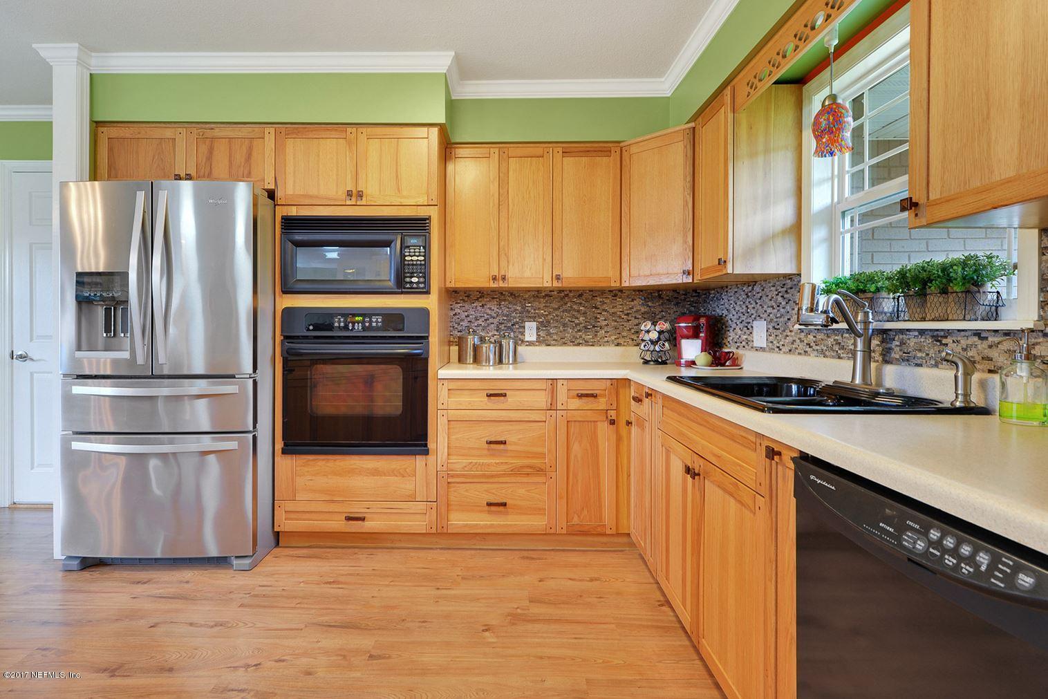 5280 Truman Pacetti Road St. Augustine, FL 32092 - Photo 5 of 34 a kitchen with stainless steel appliances a refrigerator sink and microwave