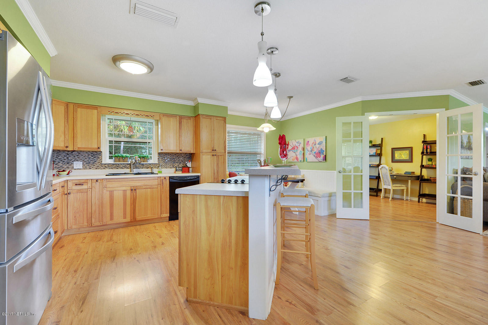 5280 Truman Pacetti Road St. Augustine, FL 32092 - Photo 9 of 34 a kitchen with stainless steel appliances granite countertop a sink a stove and a refrigerator