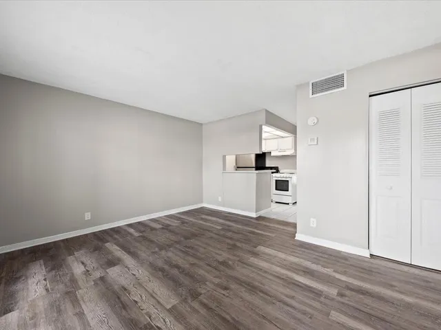 a view of kitchen with wooden floor electronic appliances and window