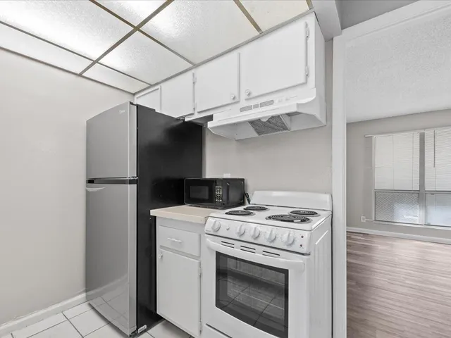 a kitchen with stainless steel appliances granite countertop a stove and a refrigerator