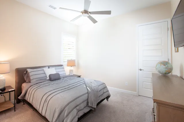 a bedroom with a bed and a chandelier