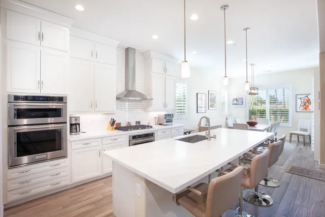 a kitchen with appliances a stove a sink and cabinets