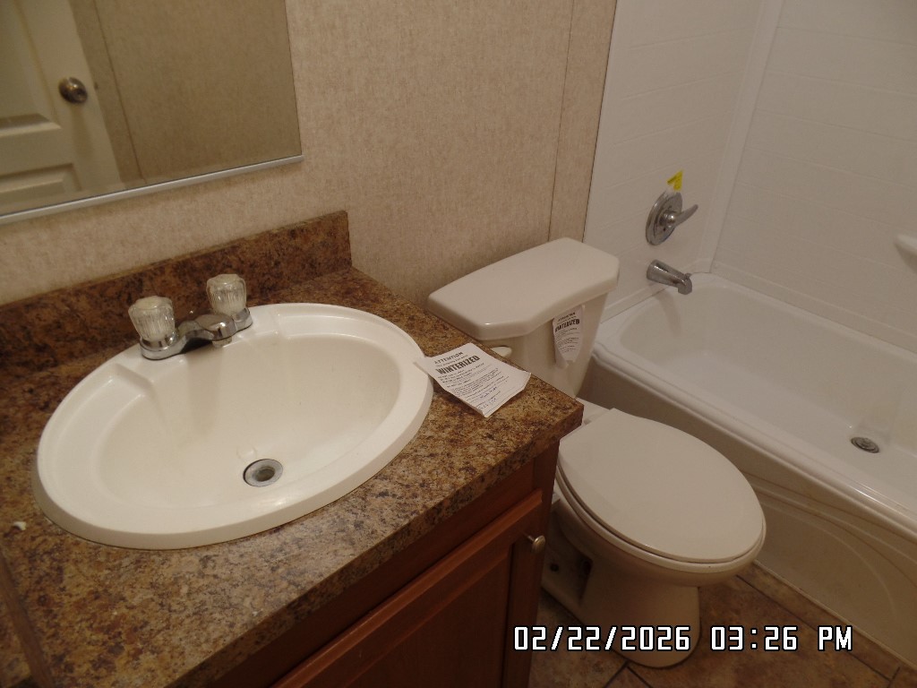 686 Ramar Road Bullhead City, AZ 86442 - Photo 16 of 22 a bathroom with a granite countertop sink and a mirror