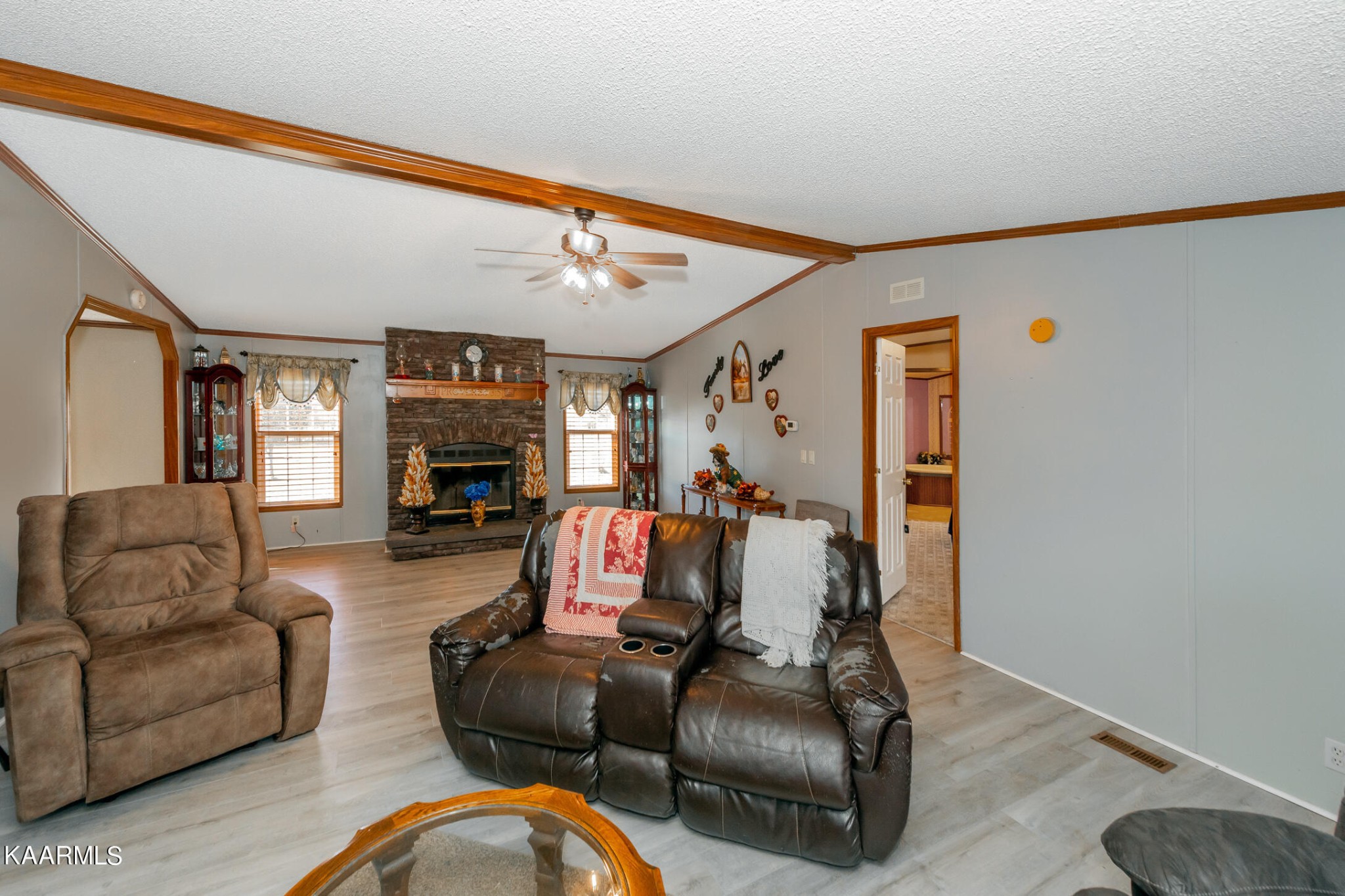 2382 River Road Kingston, TN 37763 - Photo 19 of 60 a living room with furniture a flat screen tv and a fireplace