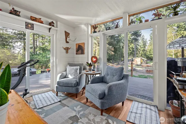 a dining room with furniture and a floor to ceiling window
