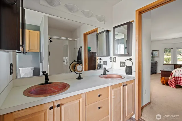 a bathroom with a sink a toilet and shower